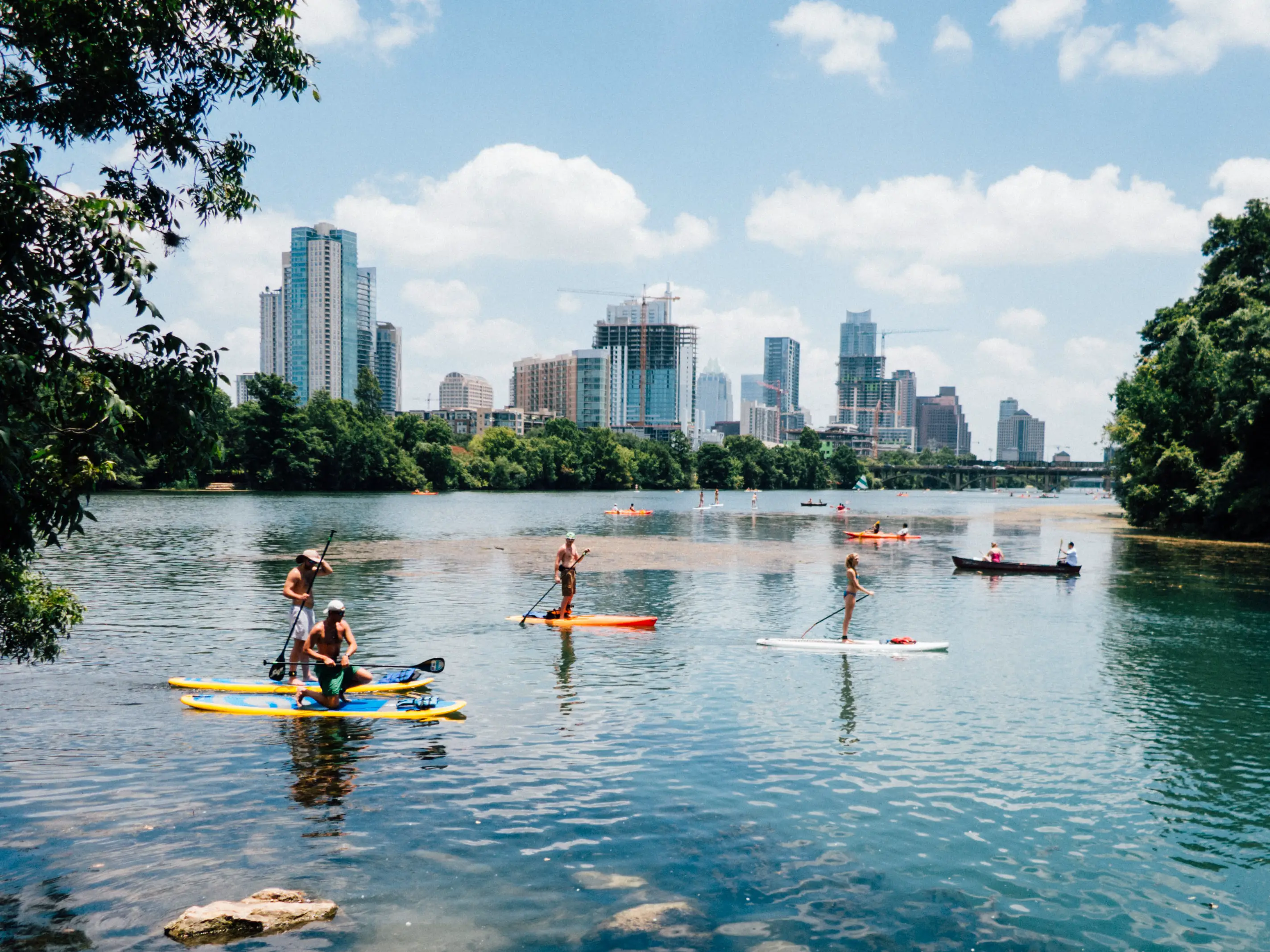 Stand up paddle board yoga with city views behind